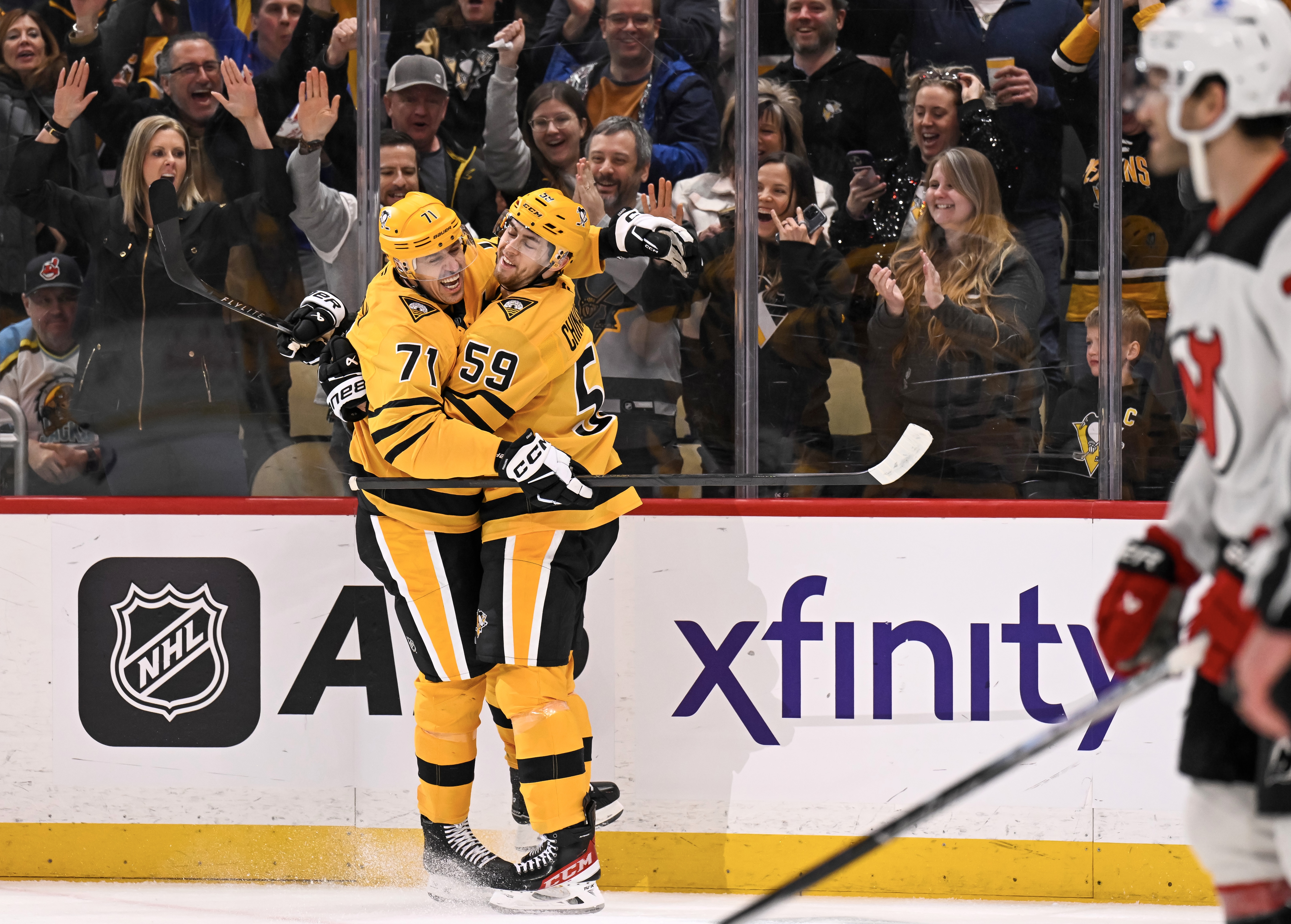 Evgeni Malkin congratulates Egor Chinakhov on the breakaway goal he set up.