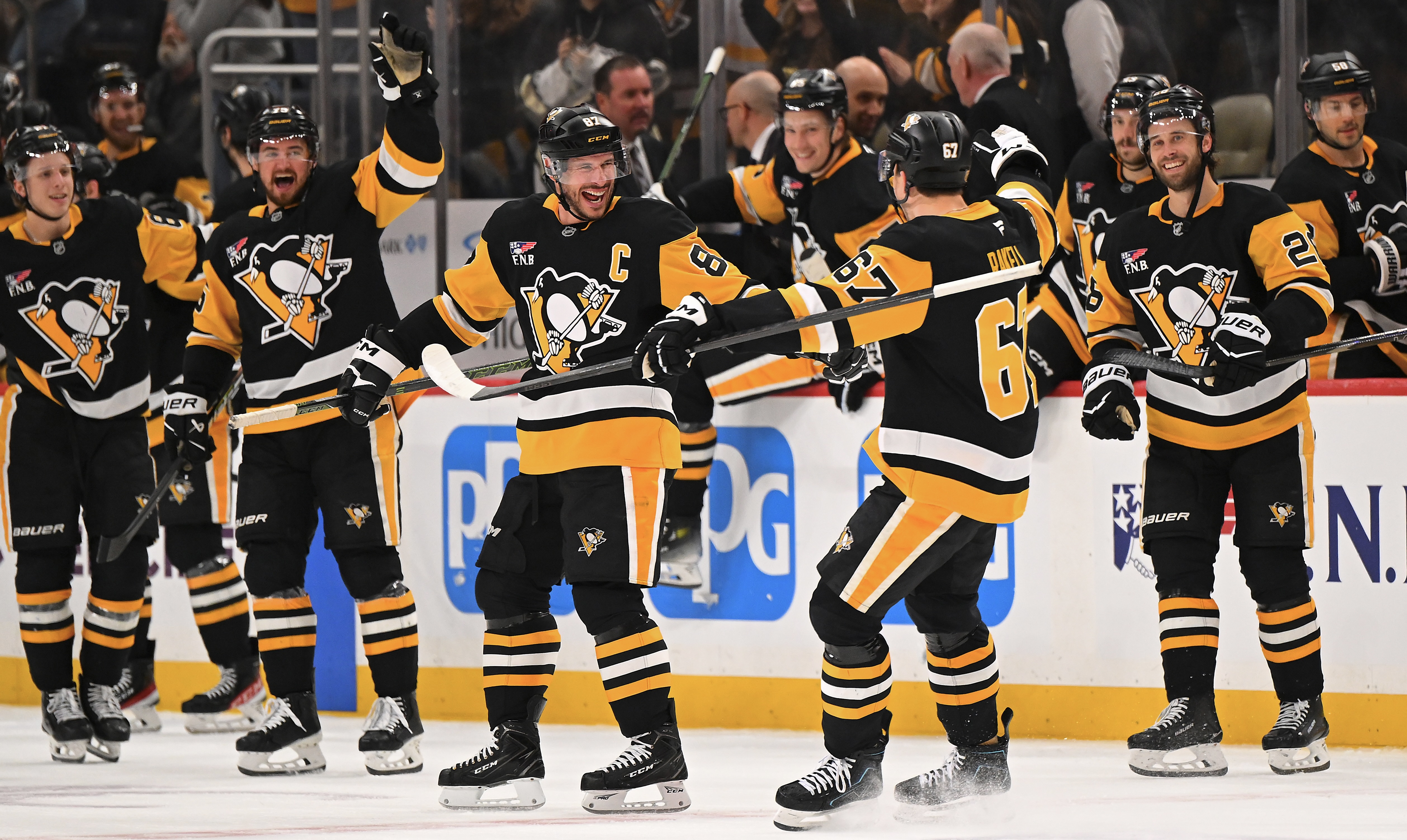 Sidney Crosby and Rickard Rakell celebrate the latter's shootout clincher Saturday at PPG Paints Arena.