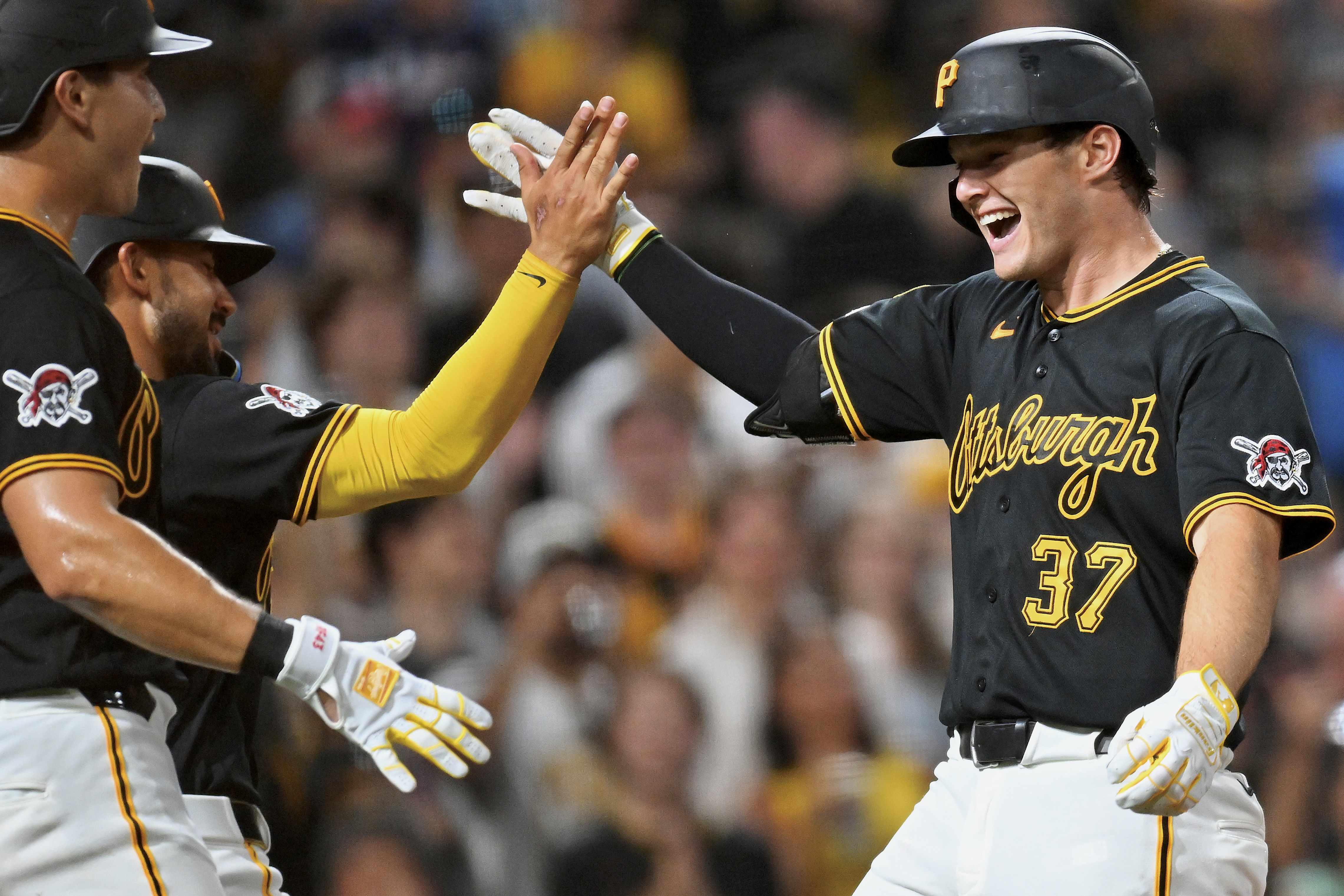 Tyler Callihan's congratulated by Rafael Flores and Nick Gonzales after his three-run home run in the eighth inning Wednesday night at PNC Park.