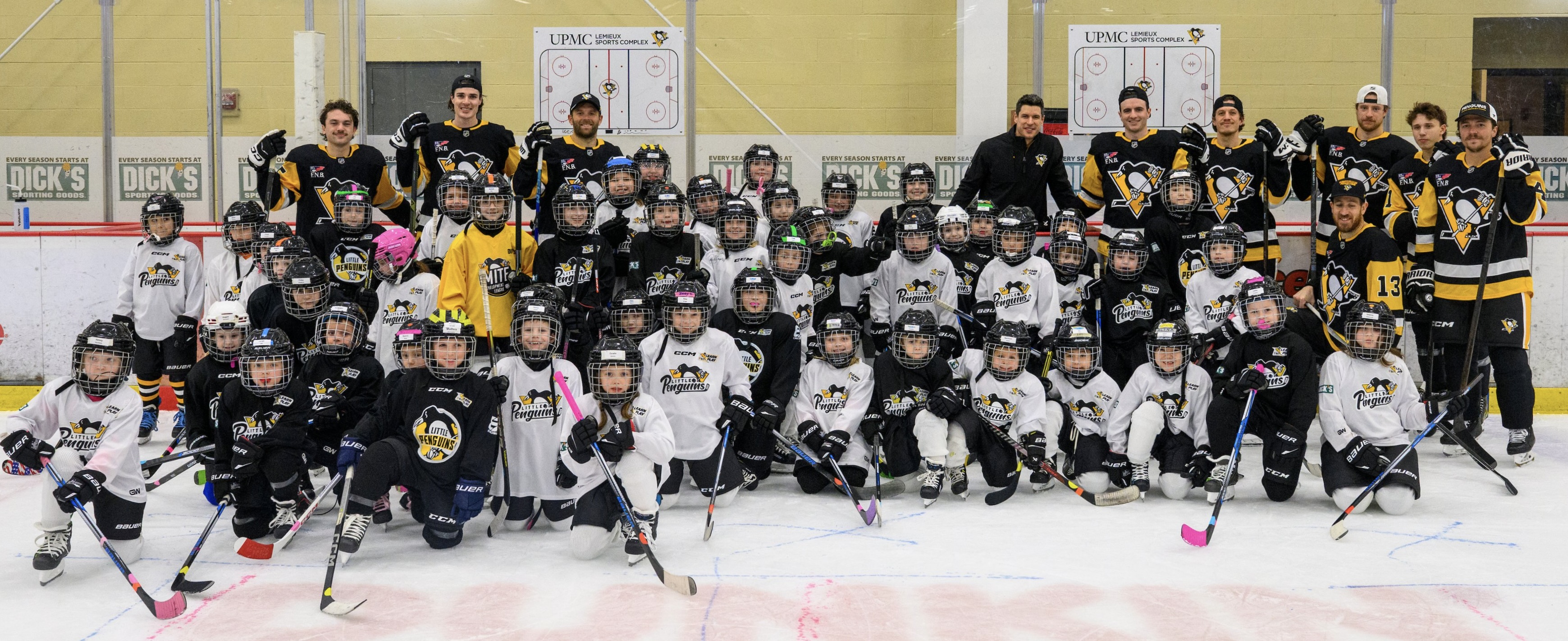 Players join the Little Penguins for a skate after practice Wednesday in Cranberry, Pa.