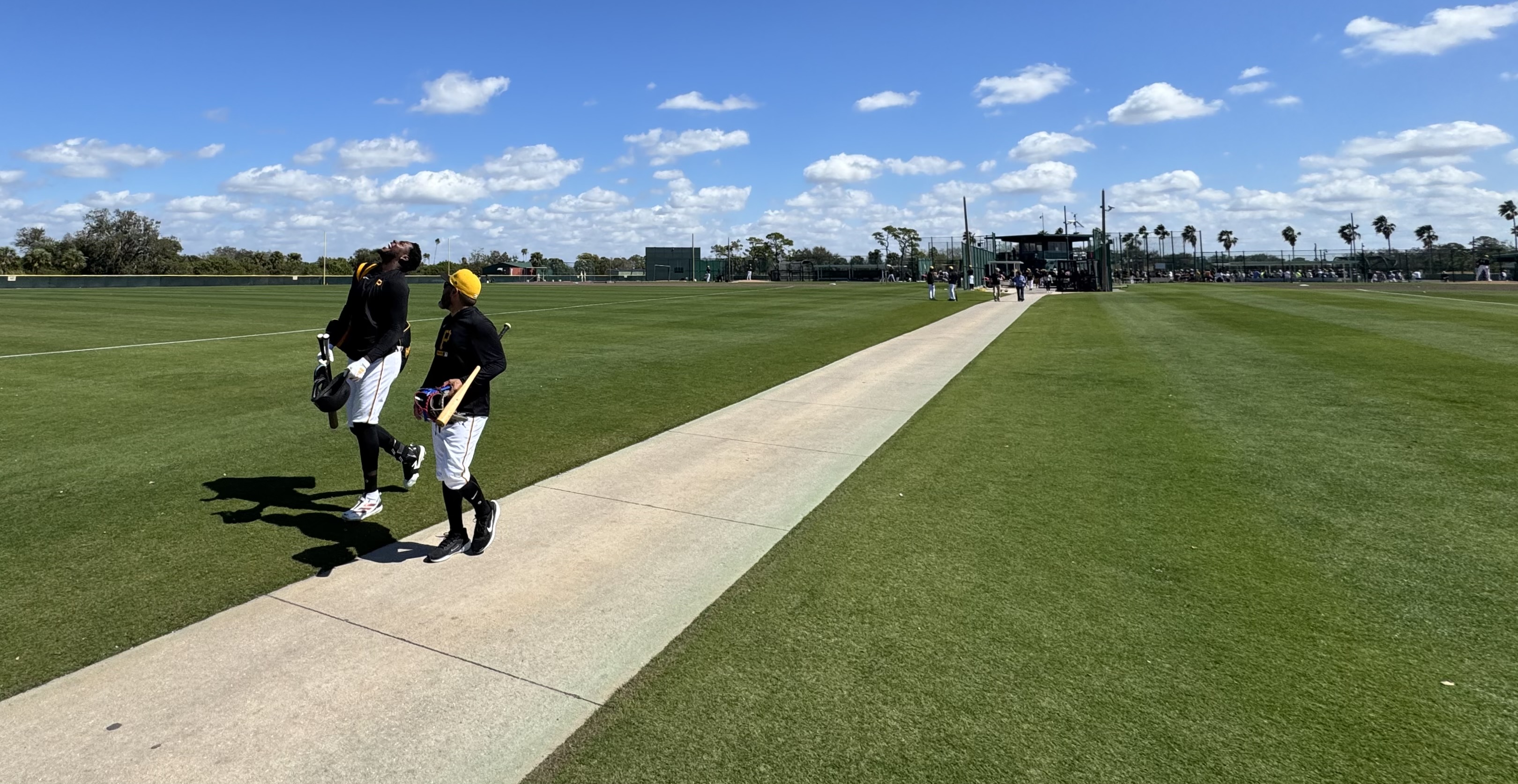 Oneil Cruz and major-league coach Stephen Morales leave the workout.