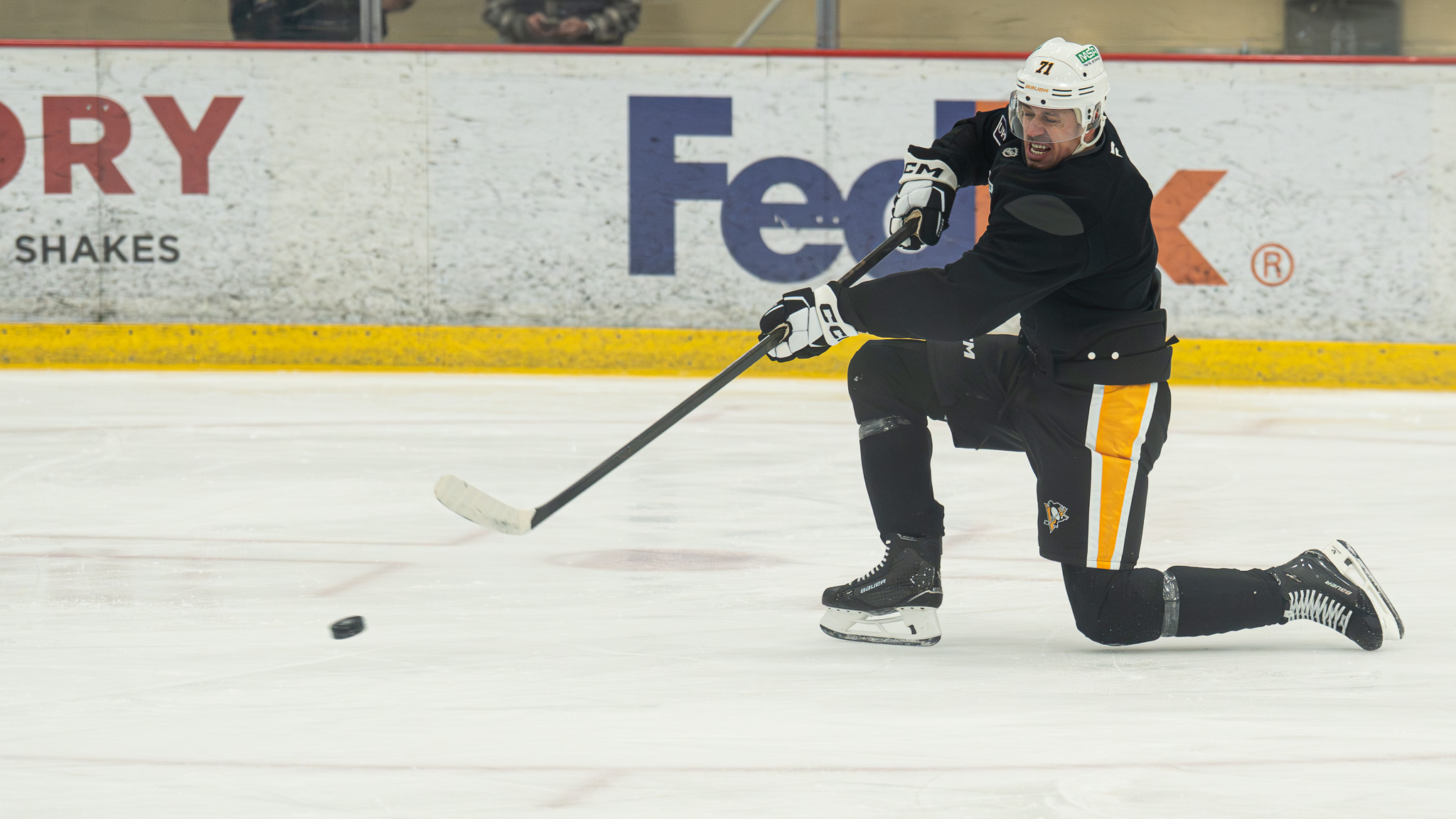 Evgeni Malkin shoots from a knee.