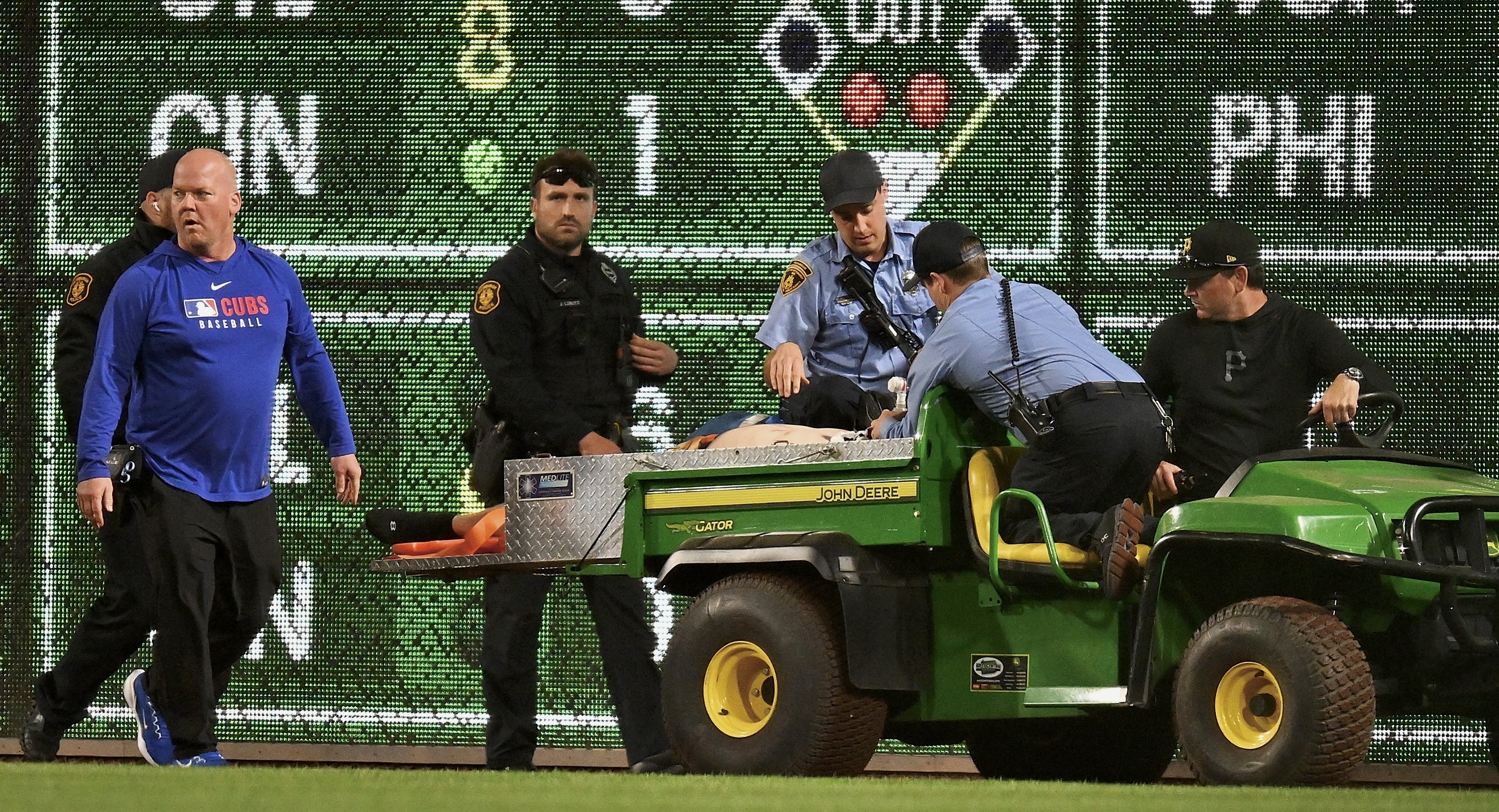 A fan is carted off the field at PNC Park on Wednesday night after falling from the Clemente Wall.
