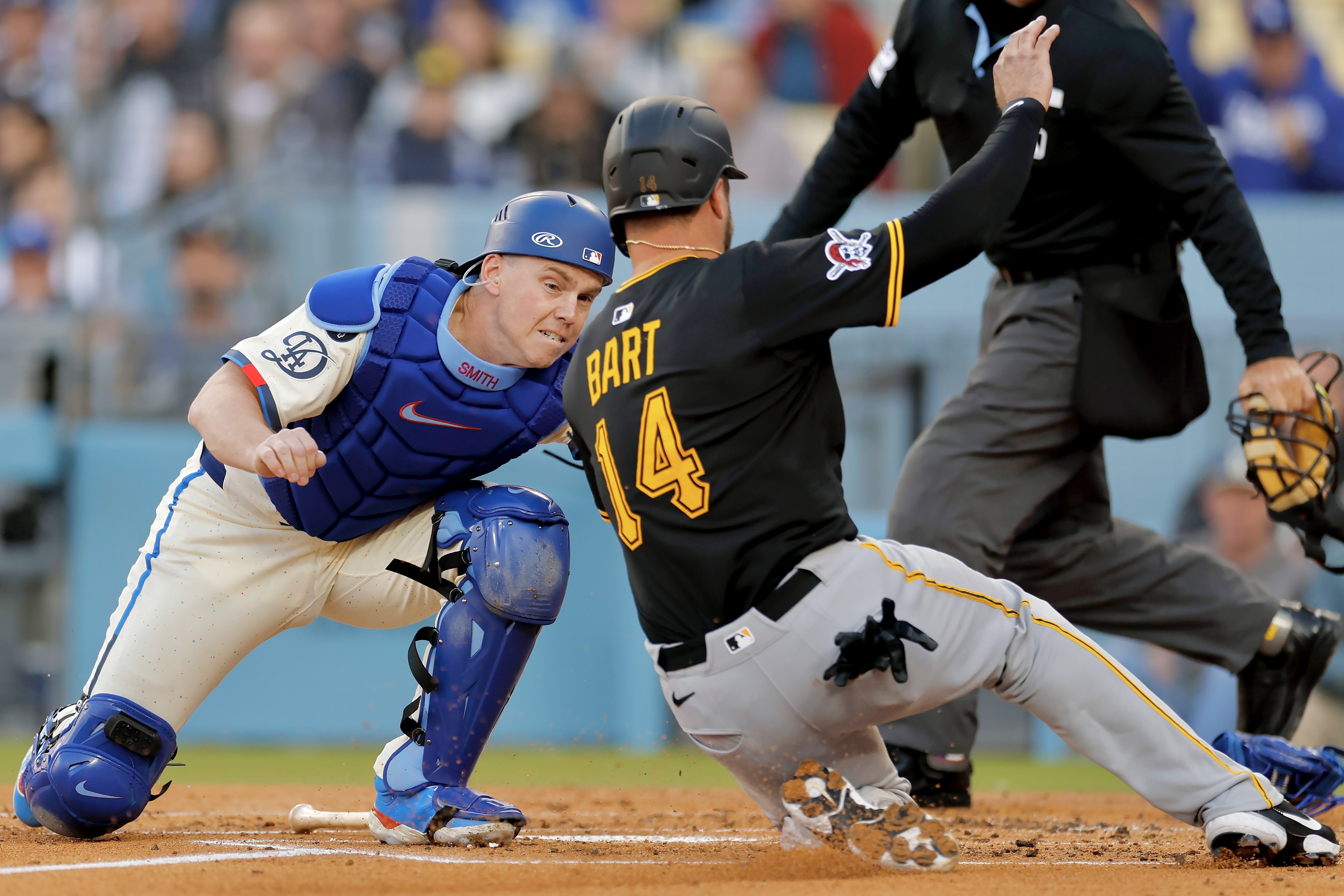 The Dodgers' Will Smith tags out Joey Bart at the plate to end the second inning Saturday night in Los Angeles.