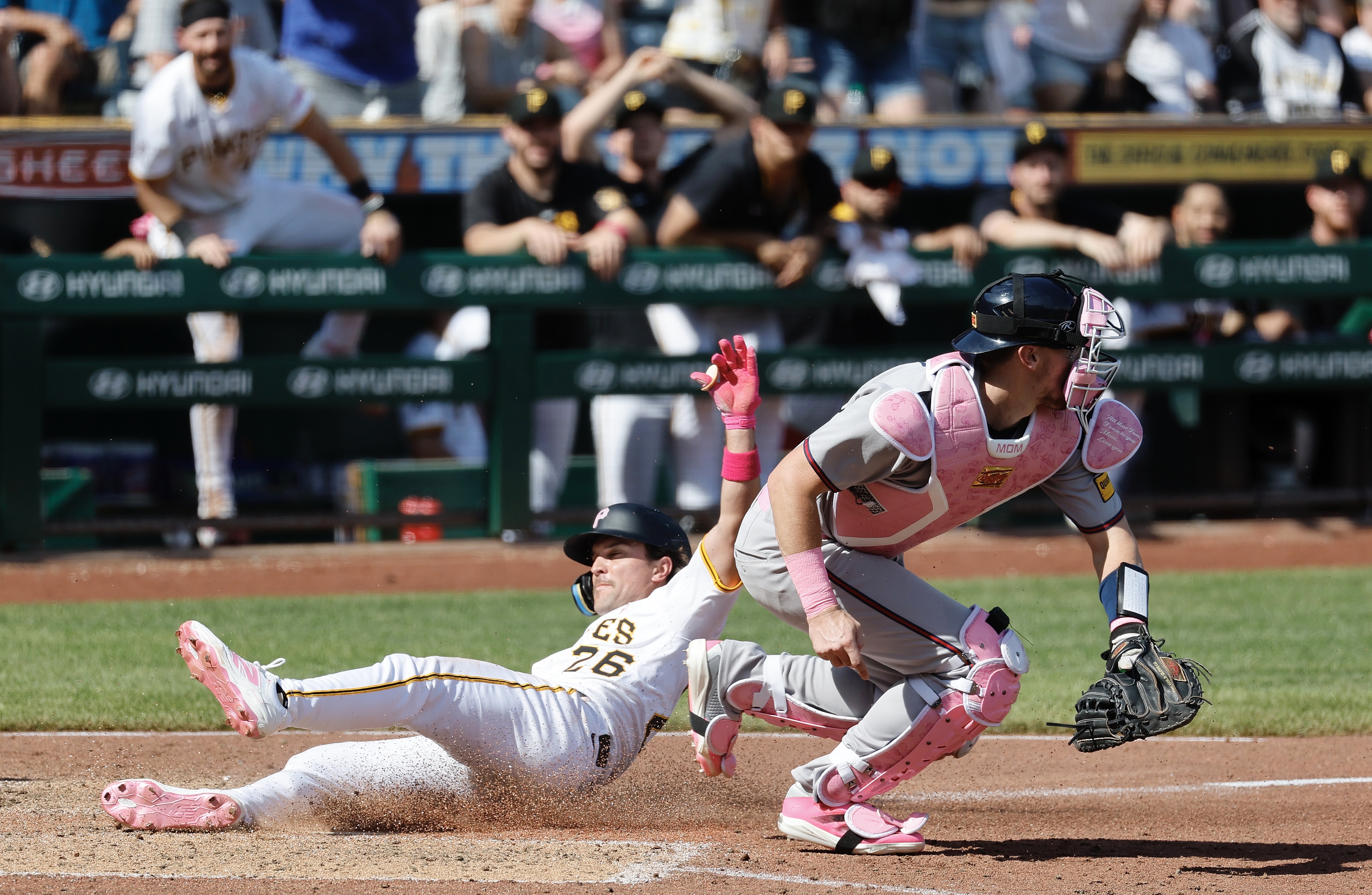 Adam Frazier slides safely ahead of the throw to the Braves' Sean Murphy for the winning run in the ninth inning Sunday at PNC Park.