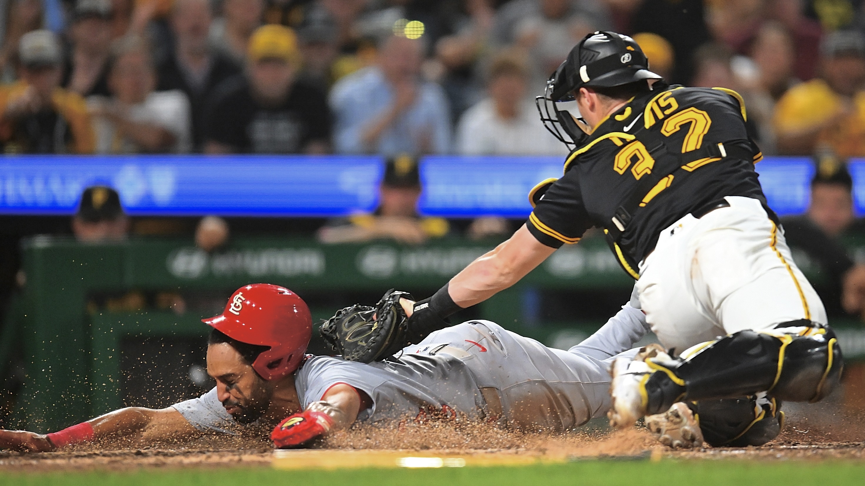 The Cardinals' José Fermín gets tagged out by Henry Davis in the ninth inning Tuesday night at PNC Park.