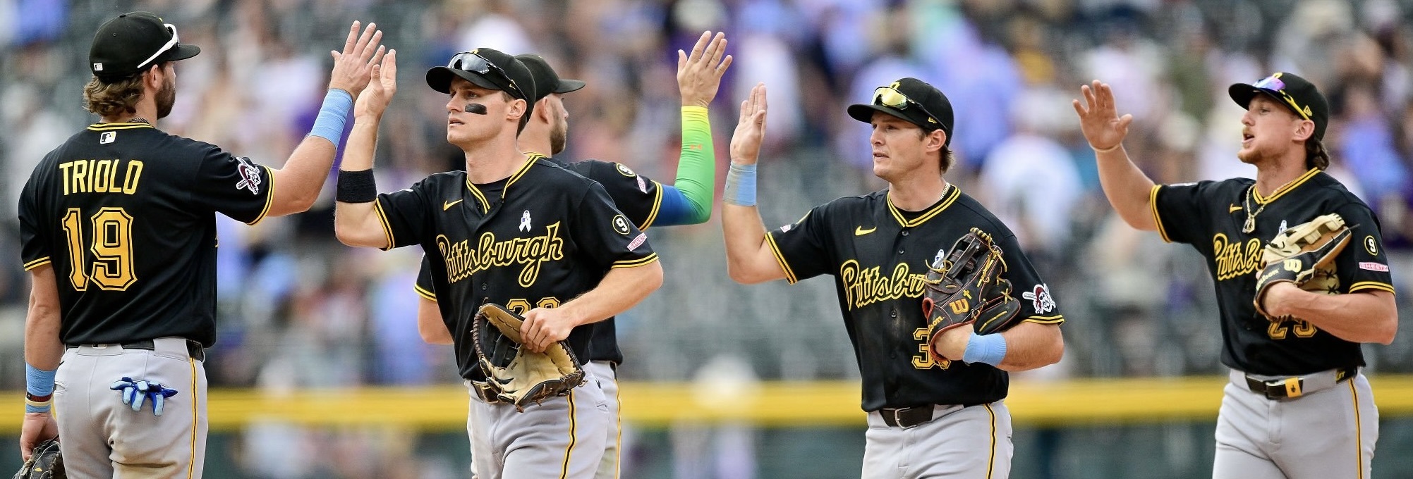Jared Triolo, Jake Mangum, Tyler Callihan and Billy Cook high-five after the victory Sunday in Denver.