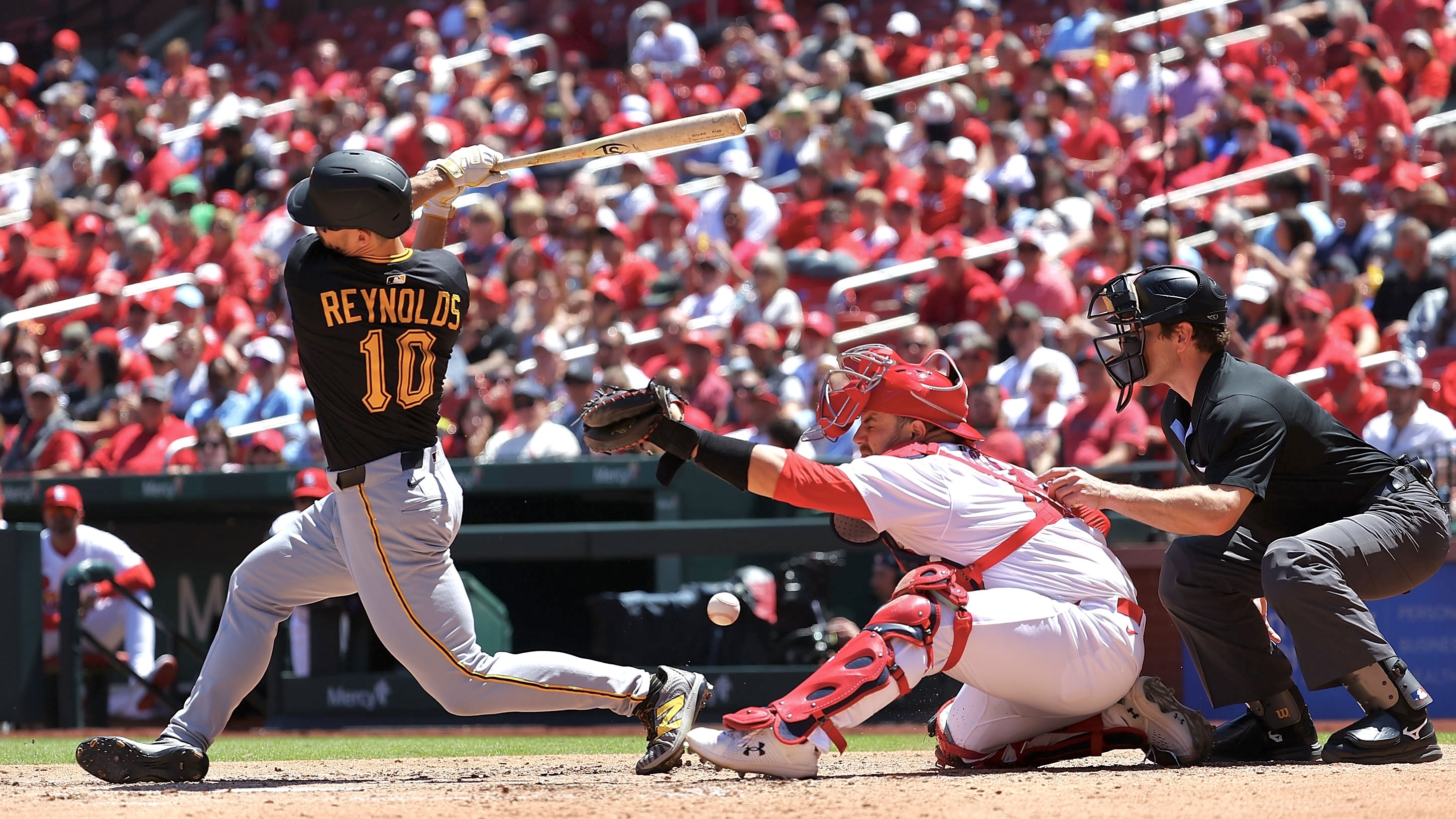 Bryan Reynolds foul-tips a pitch off the mask of the Cardinals' Pedro Pagés in the sixth inning Wednesday in St Louis.