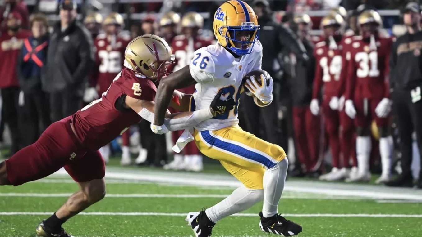 Juelz Goff tries to shake off Boston College linebacker Kam Arnold at Alumni Stadium.