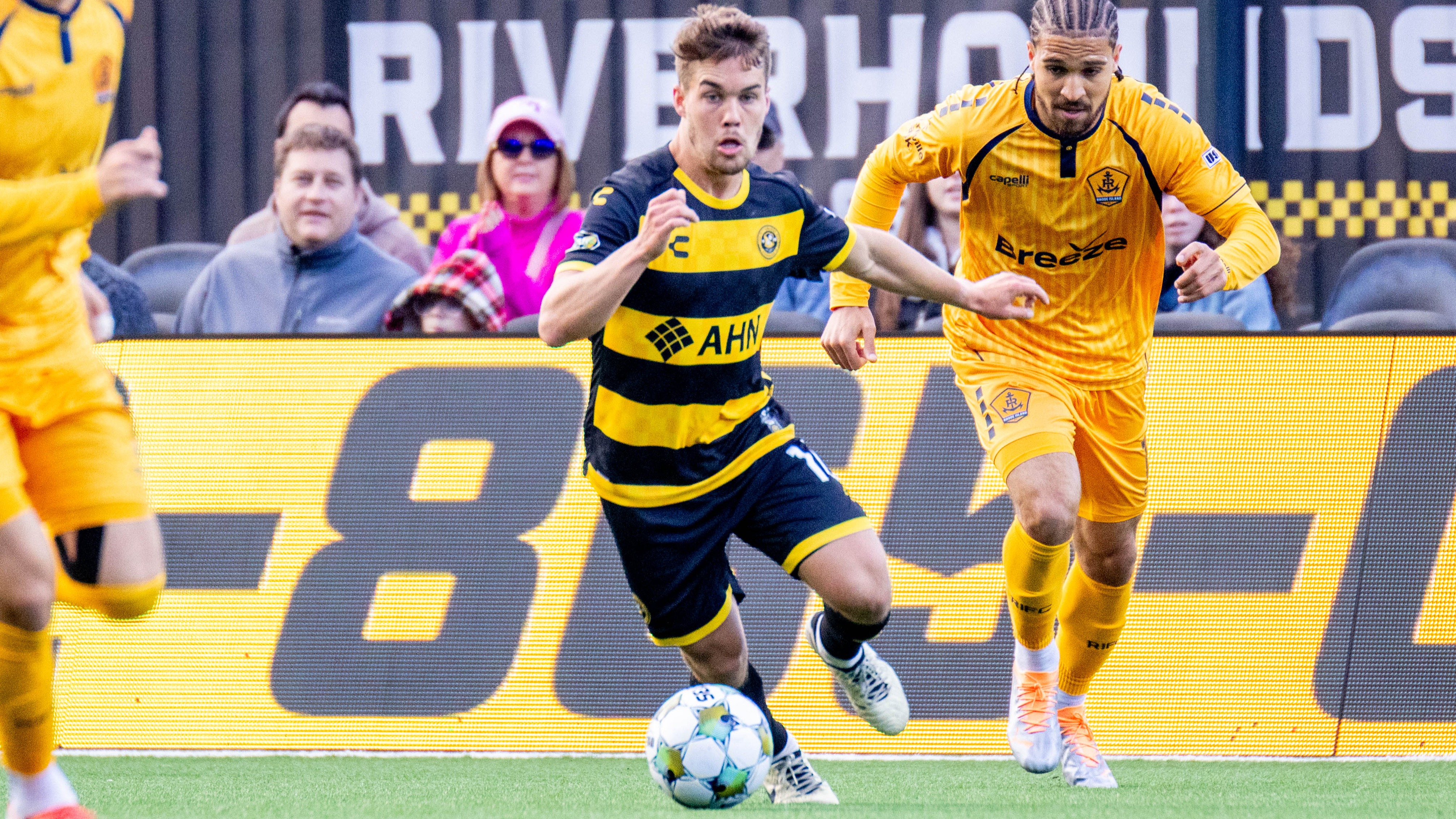 Riverhounds midfielder Robbie Mertz evades Rhode Island FC's Rio Hope-Gund