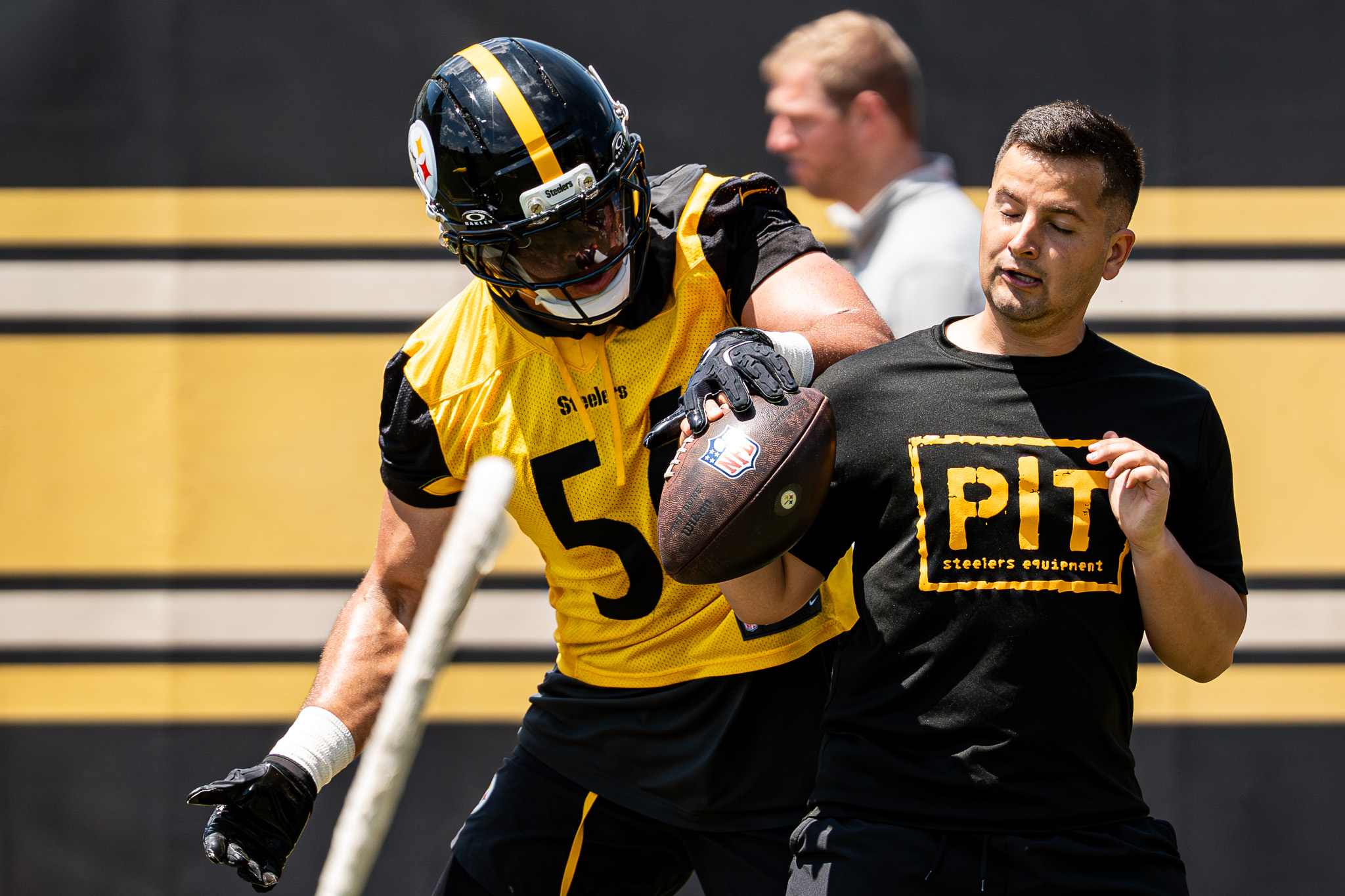 Alex Highsmith strips the ball from a Steelers staffer during outside linebacker drills on the South Side. 