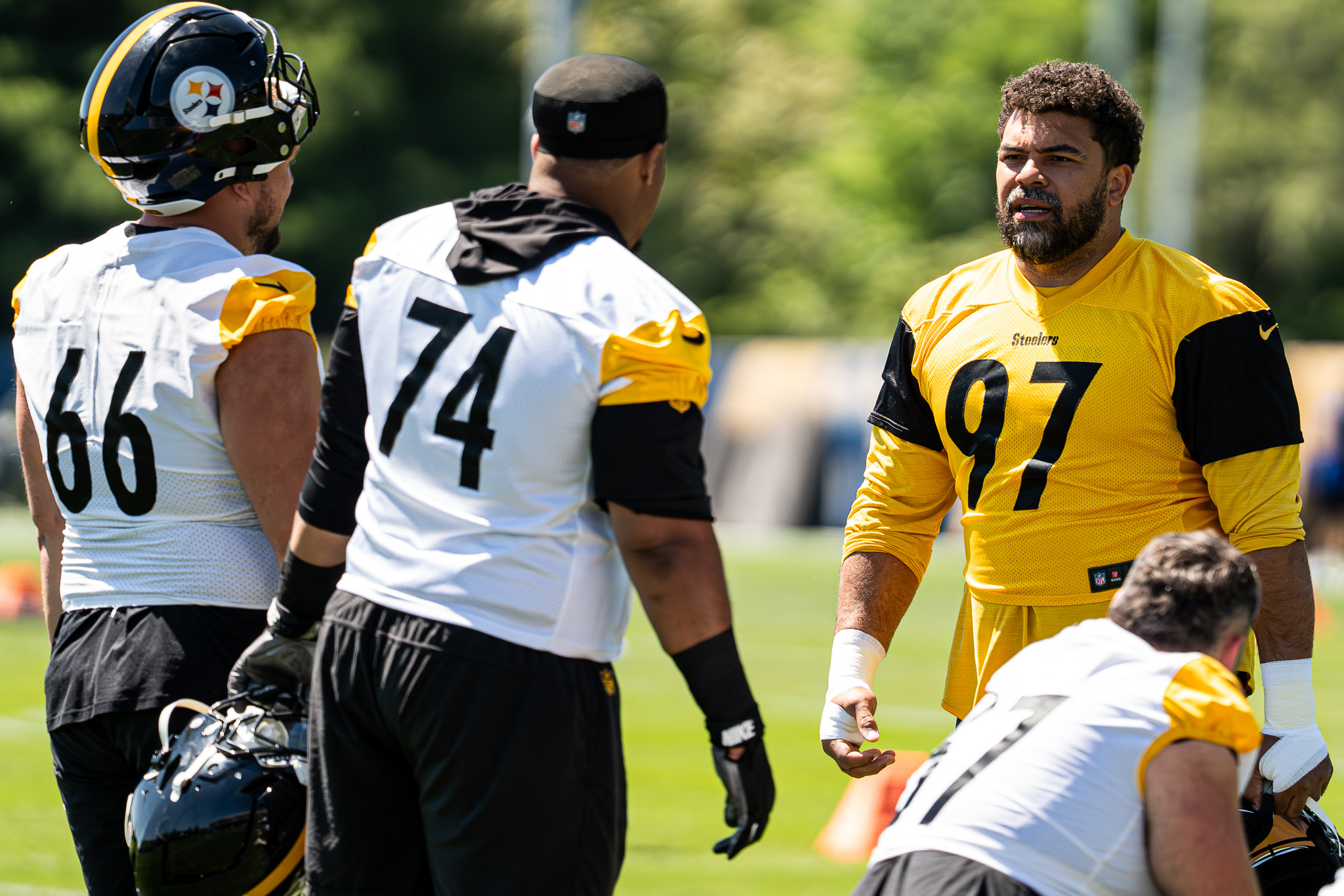 Cam Heyward and offensive linemen Mason McCormick and Spencer Anderson joke around during the team's stretching period.