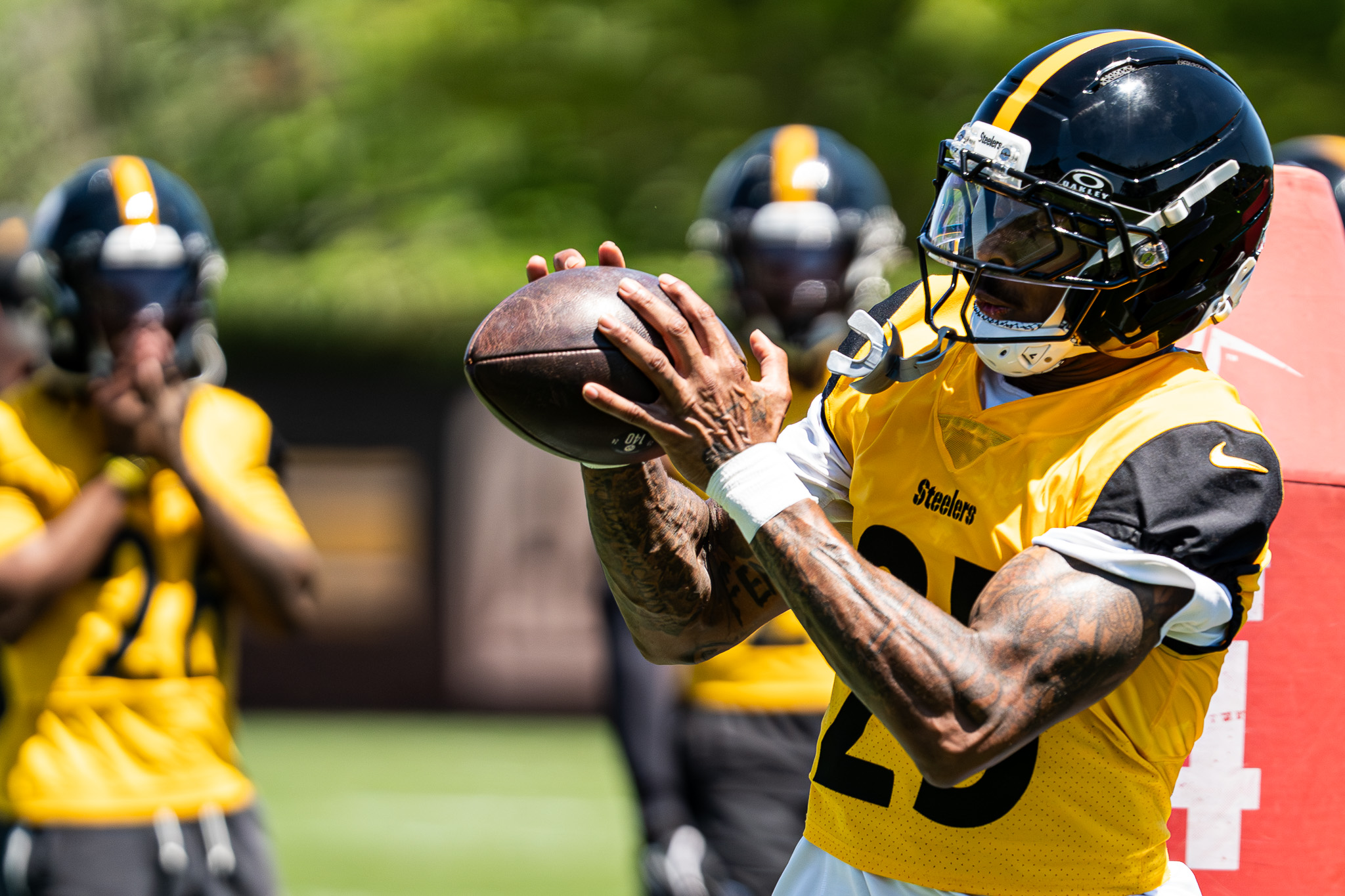 DeShon Elliott looks in a ball during a drill with defensive backs and wide receivers.