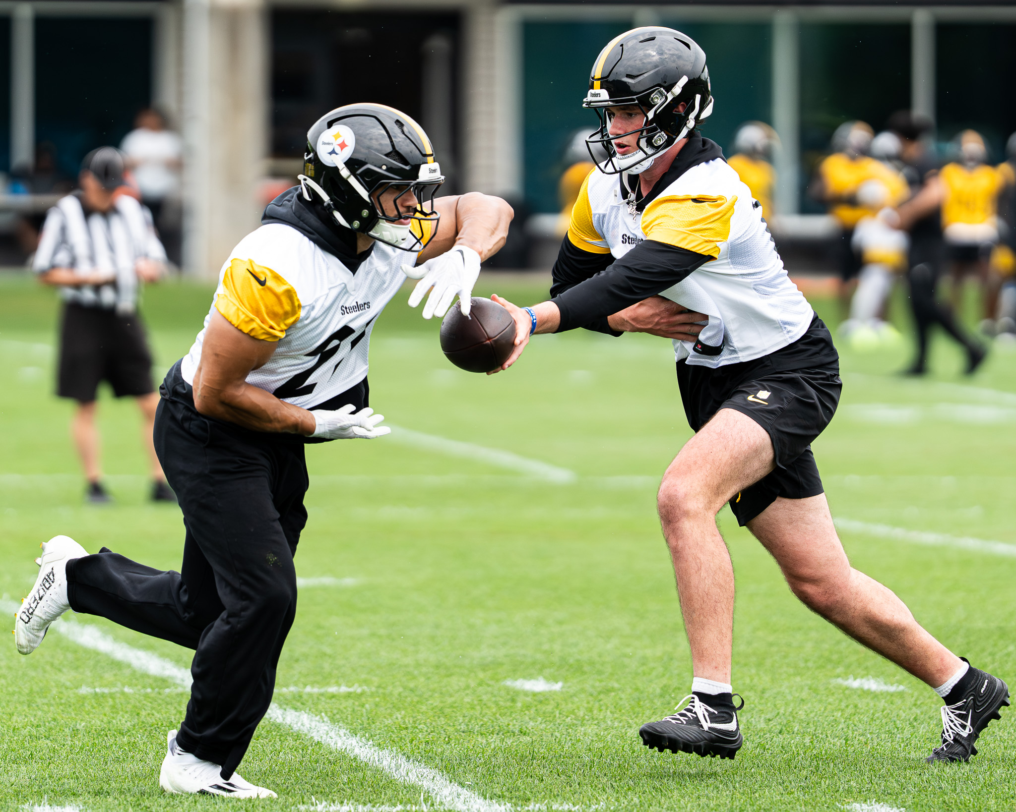Drew Allar hands a ball off to Travis Homer at the UPMC Rooney Sports Complex on Tuesday. 