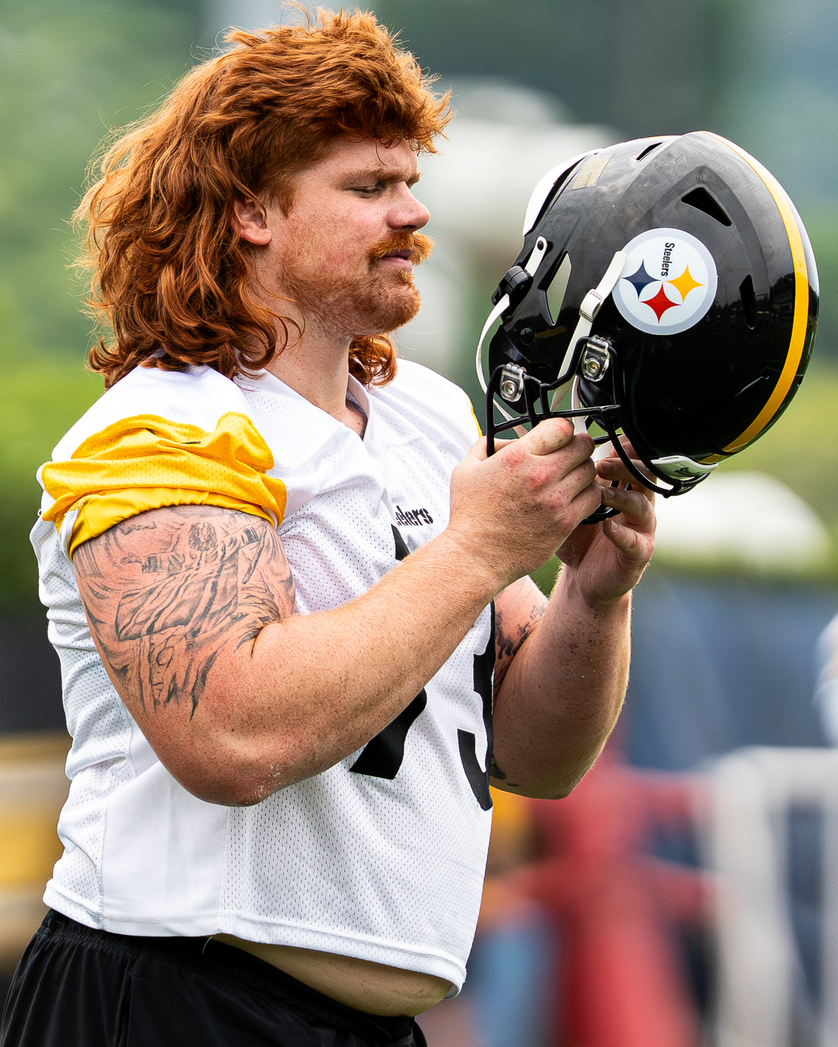 Gennings Dunker puts on his helmet during the stretching period of Tuesday's practice.