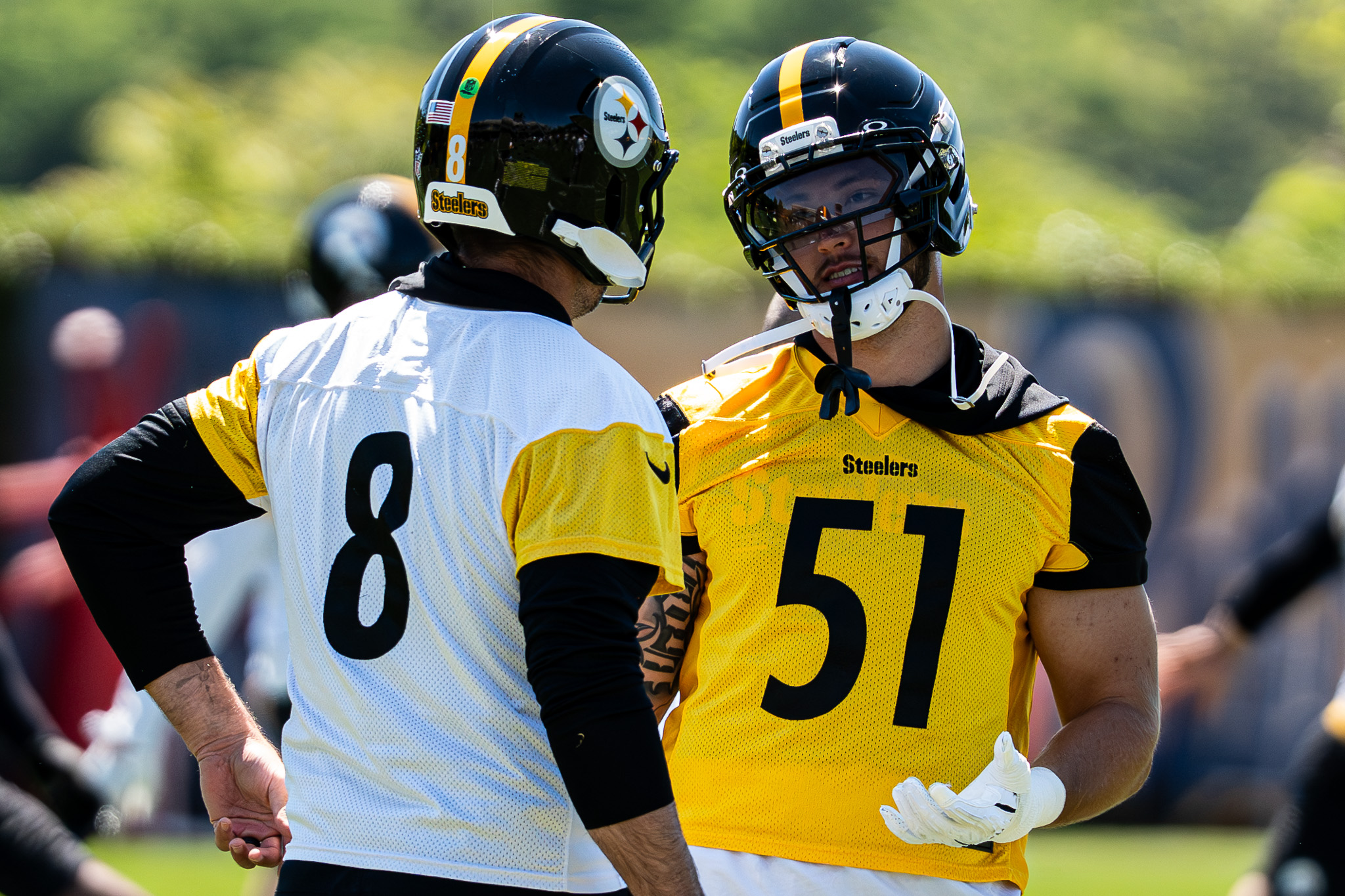The $100 million dollar man, Nick Herbig, chats with Aaron Rodgers during the team's stretching period Wednesday on the South Side. 