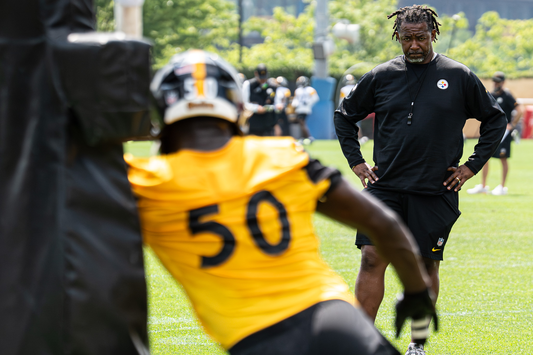 Patrick Graham watches edge rushers work through a pass-rushing drill. 