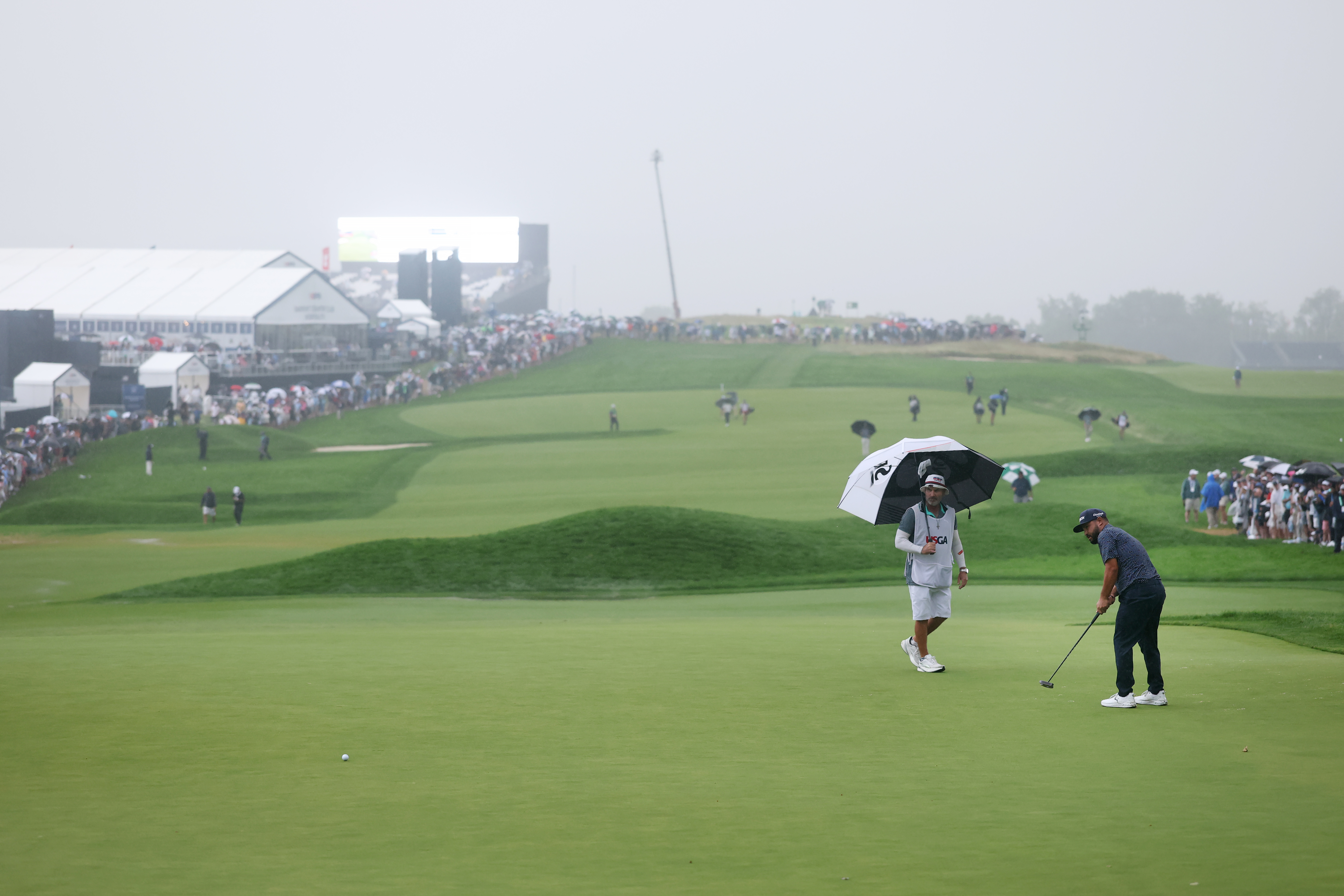 J.J. Spaun putts on the 18th green Sunday in Oakmont, Pa.