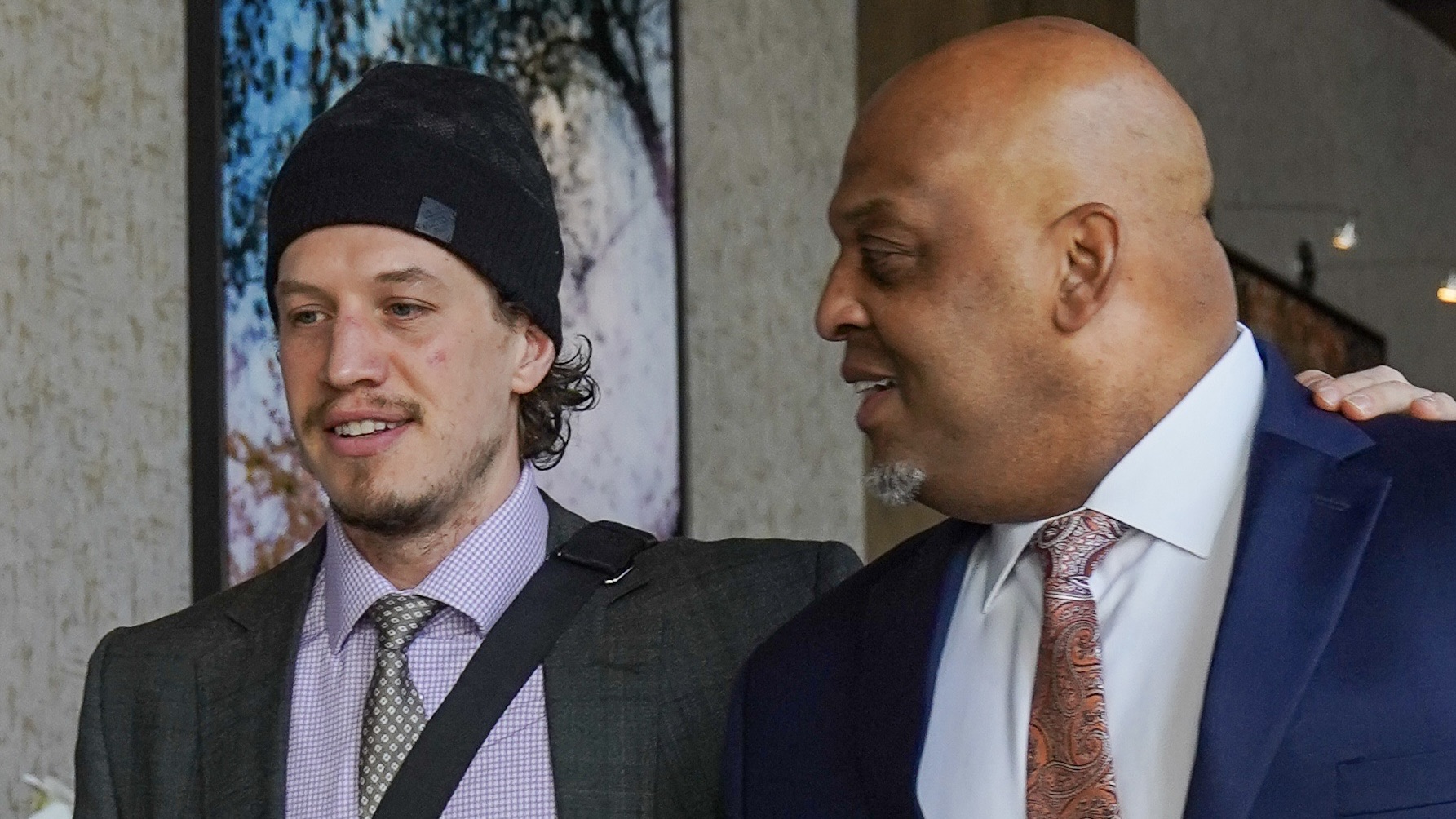 Rickard Rakell walks with his arm around Ed Joyner