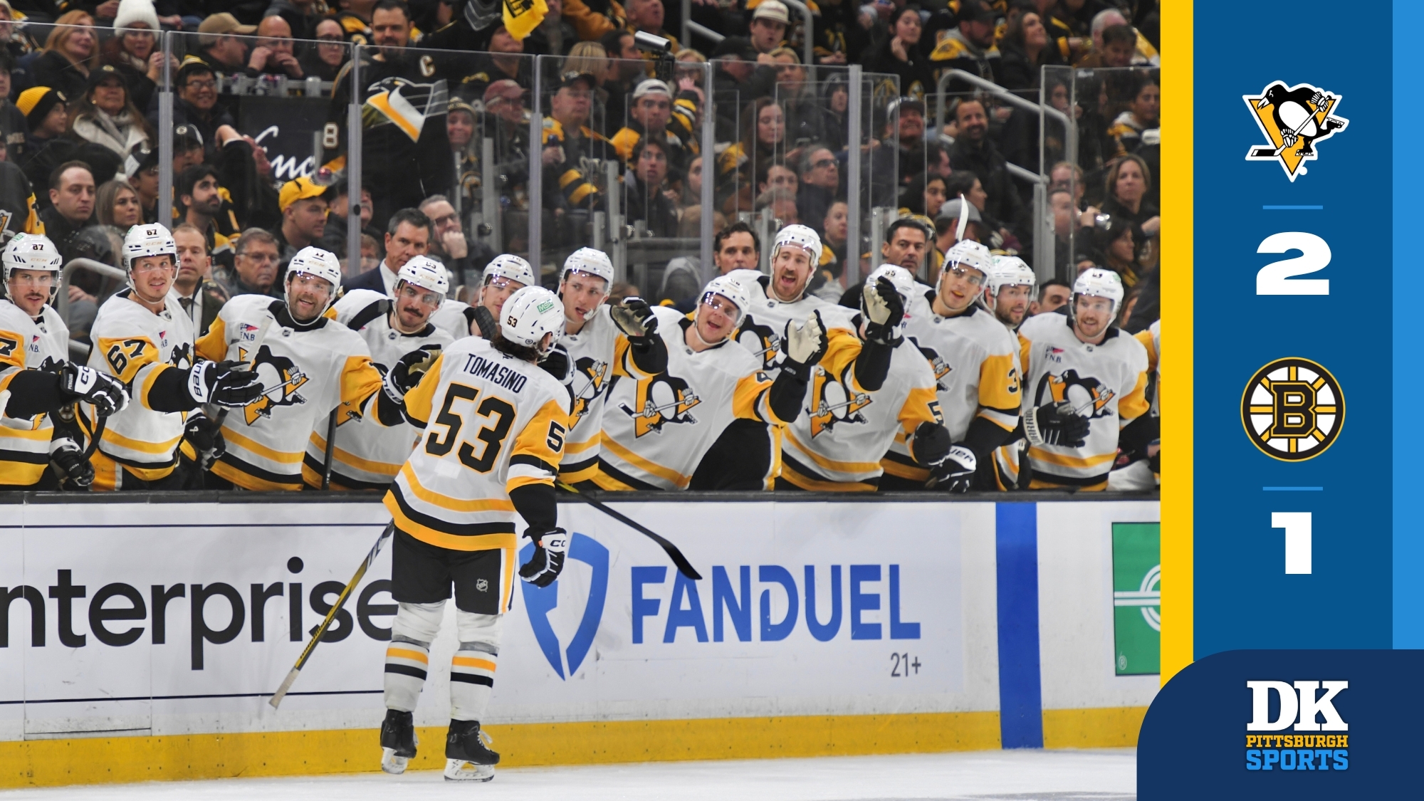 Philip Tomasino celebrates his third-period goal at the visiting bench Friday night in Boston.