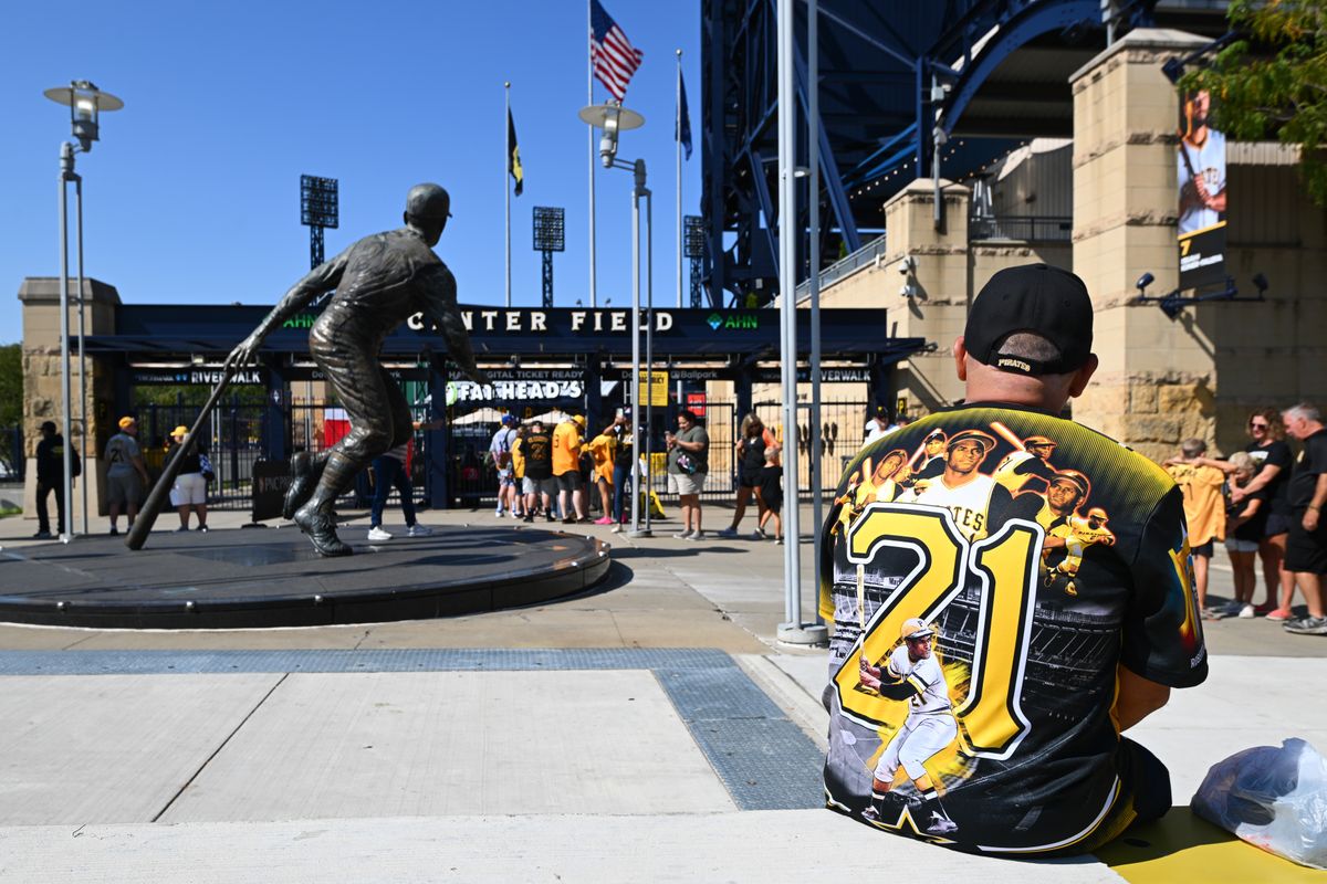 A fan sits near the Roberto Clemente statue Thursday outside PNC Park. A fan sits near the Roberto Clemente statue Thursday outside PNC Park.