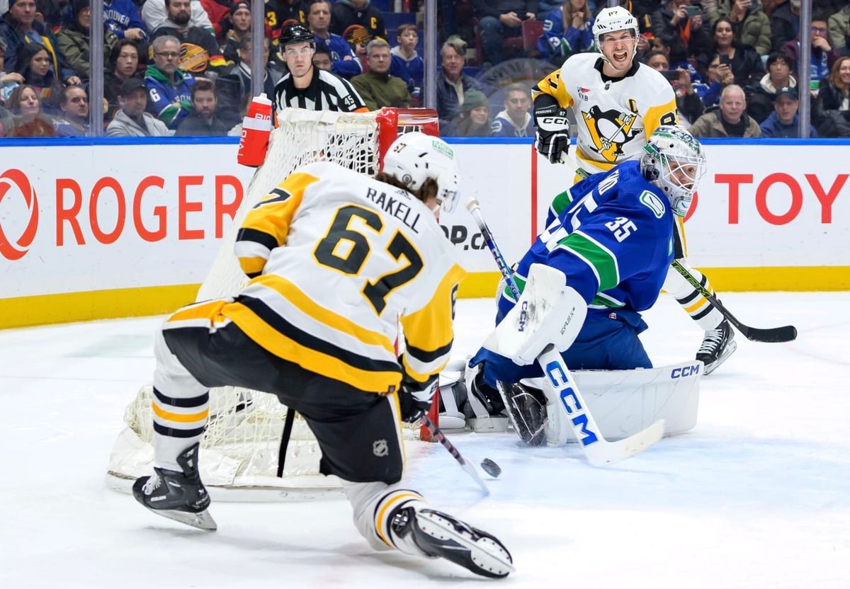 Rickard Rakell converts a Sidney Crosby pass for a power-play goal Tuesday night in Vancouver, British Columbia.