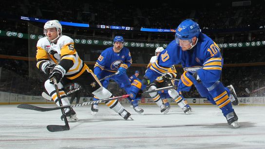 Ryan Shea and Henri Jokiharju battle for the puck Friday night in Buffalo, N.Y. Ryan Shea and Henri Jokiharju battle for the puck Friday night in Buffalo, N.Y.