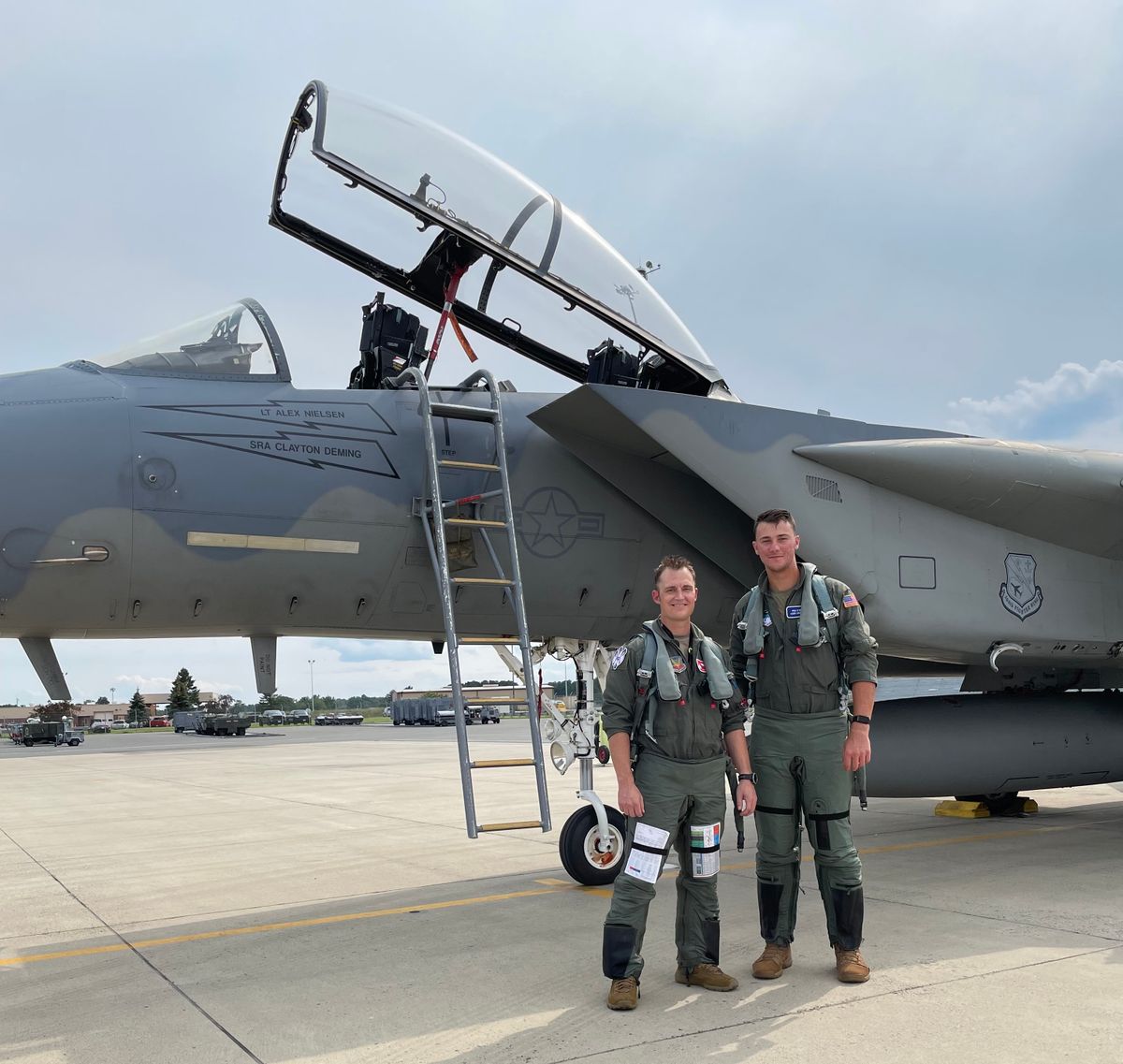 Paul Skenes, right, stands in front of an F-15 fighter jet. Paul Skenes, right, stands in front of an F-15 fighter jet.
